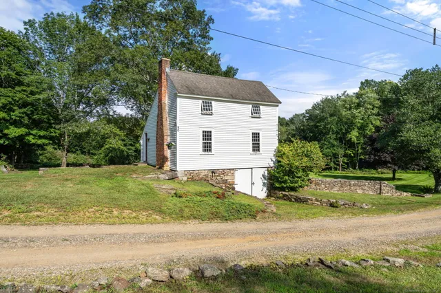 a backyard of a house with plants and trees