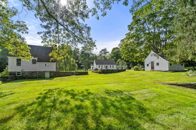 a house view with swimming pool in front of it