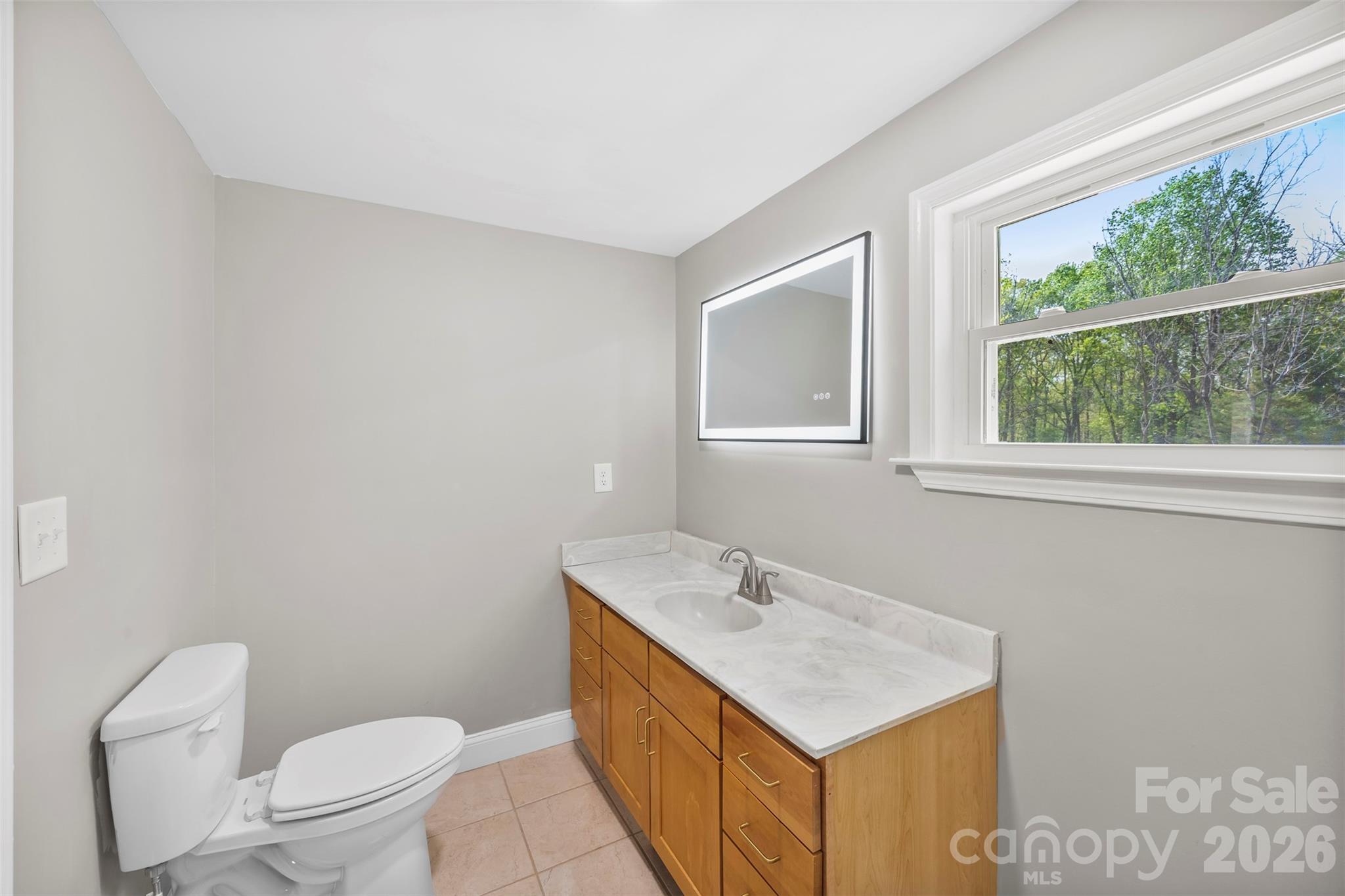 858 High Shoals Church Road Mooresboro, NC 28114 - Photo 11 of 25 a bathroom with a sink toilet vanity and window