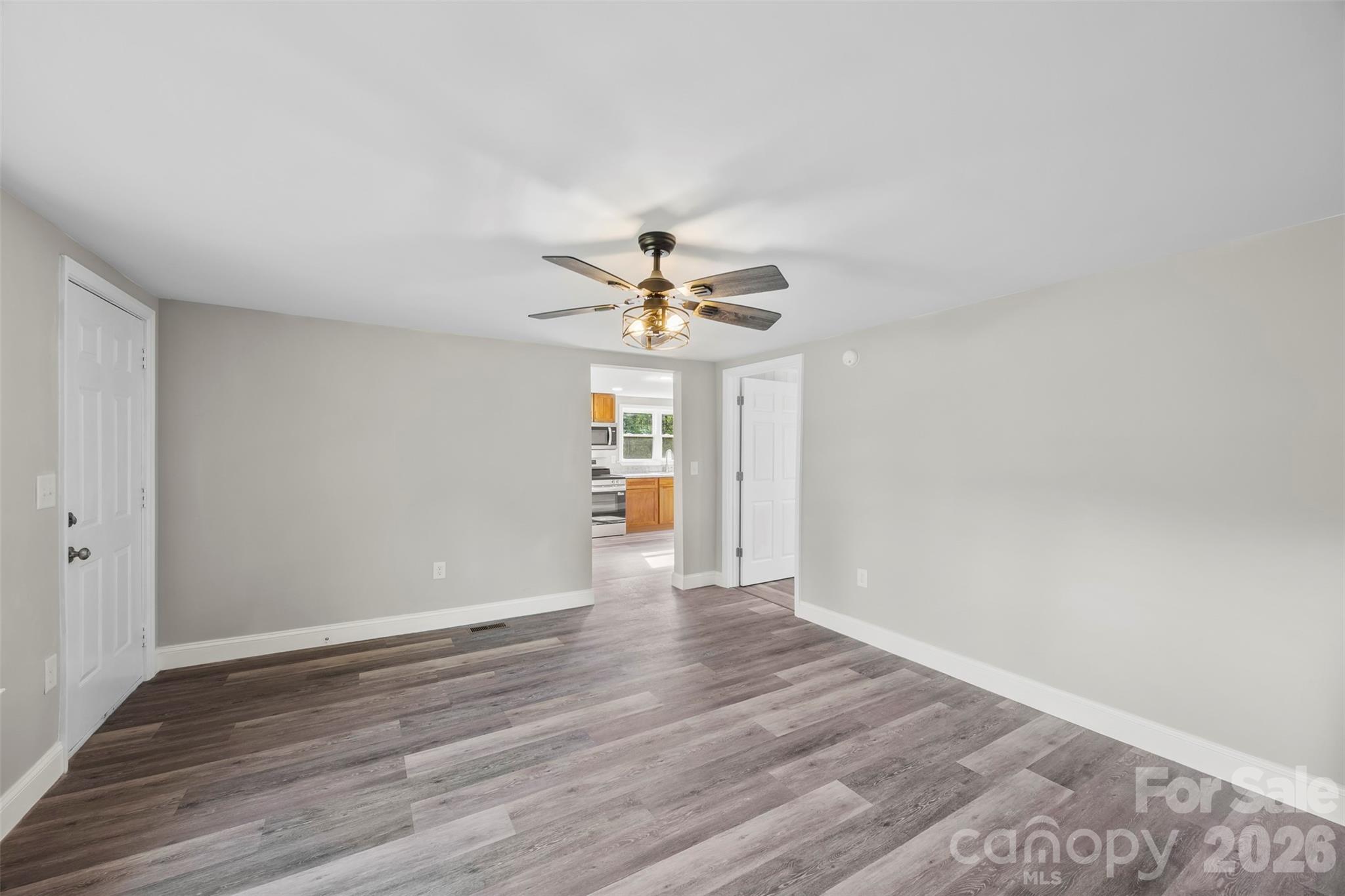 858 High Shoals Church Road Mooresboro, NC 28114 - Photo 13 of 25 a view of a livingroom with wooden floor and a ceiling fan