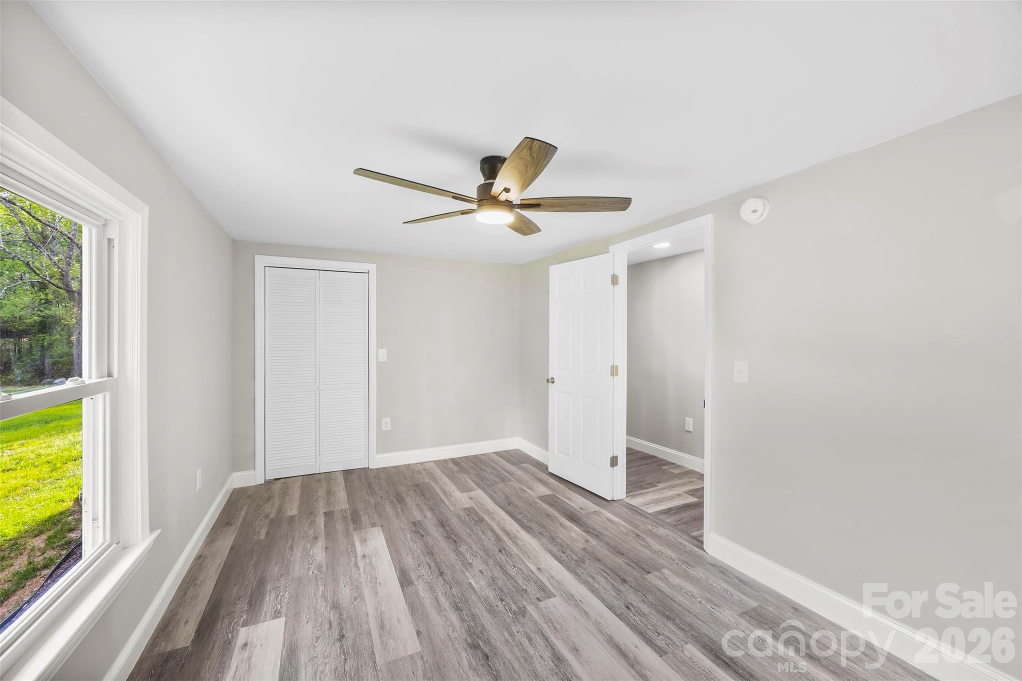 858 High Shoals Church Road Mooresboro, NC 28114 - Photo 18 of 25 a view of a livingroom with wooden floor and a ceiling fan