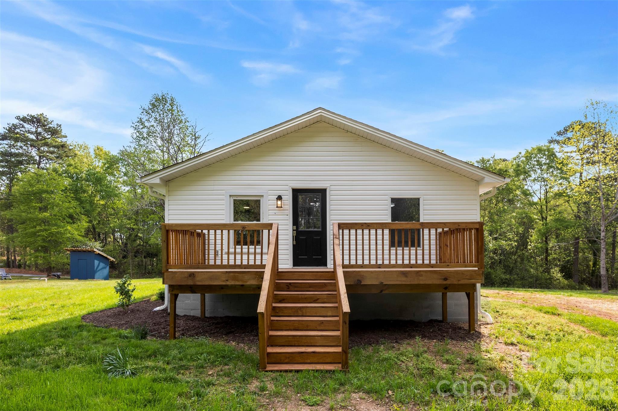 858 High Shoals Church Road Mooresboro, NC 28114 - Photo 24 of 25 a front view of a house with a garden and deck