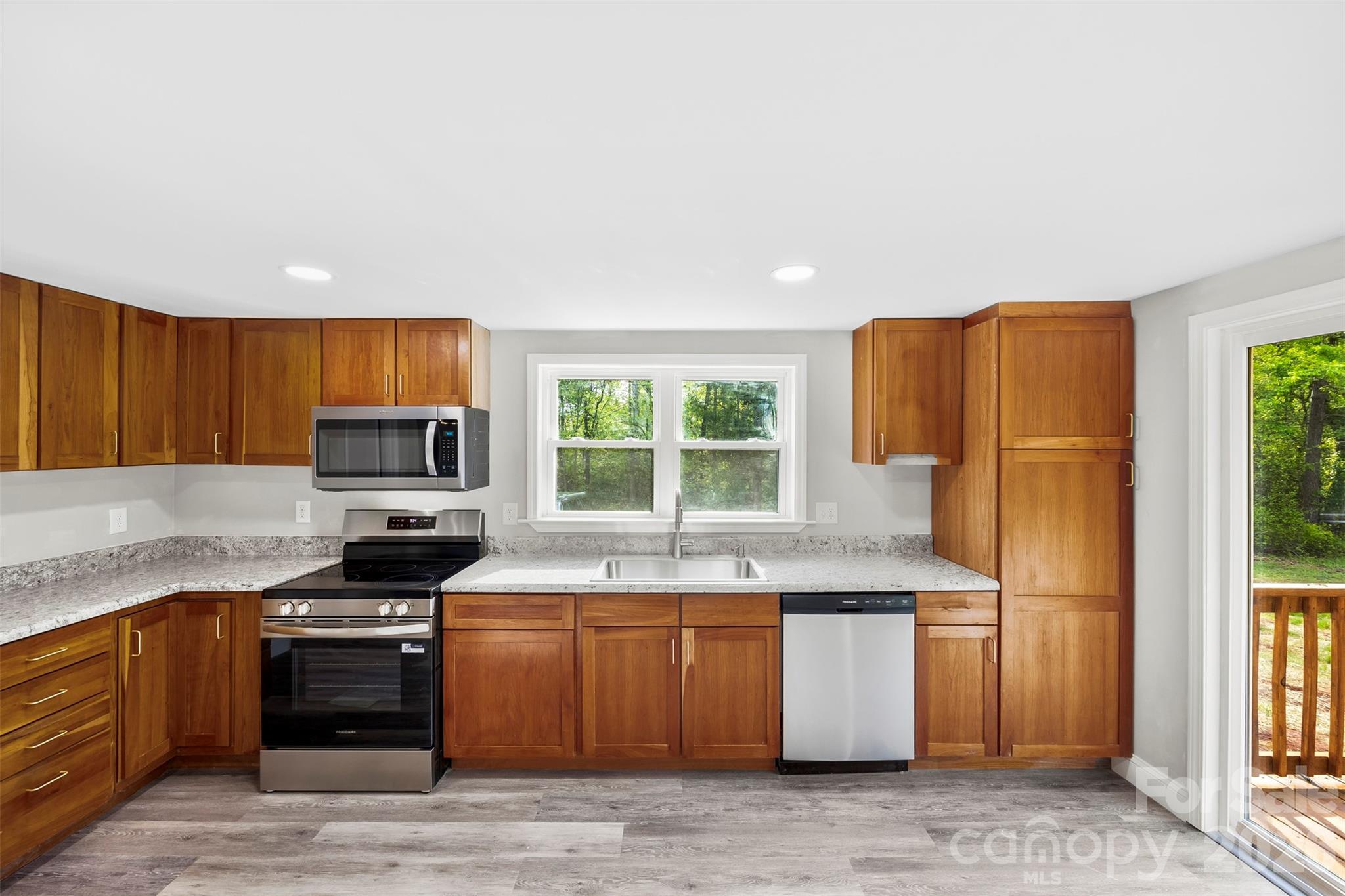 858 High Shoals Church Road Mooresboro, NC 28114 - Photo 6 of 25 a kitchen with stainless steel appliances granite countertop a stove a sink and a refrigerator