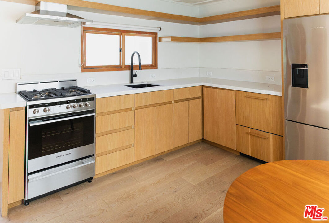 43 Paradise Cove Road Malibu, CA 90265 - Photo 3 of 21 a kitchen with a stove and a refrigerator