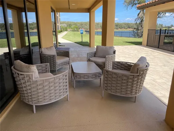 a living room with furniture and a floor to ceiling window