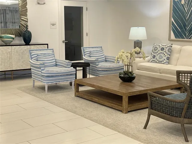 a living room with furniture and a lamp