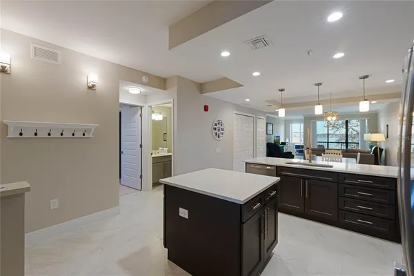 a kitchen with a sink a counter top space and stainless steel appliances