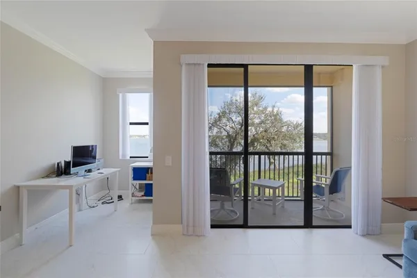 a view of a bedroom with a bed and a window