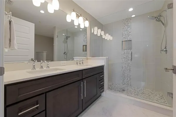 a bathroom with a sink double vanity and a shower
