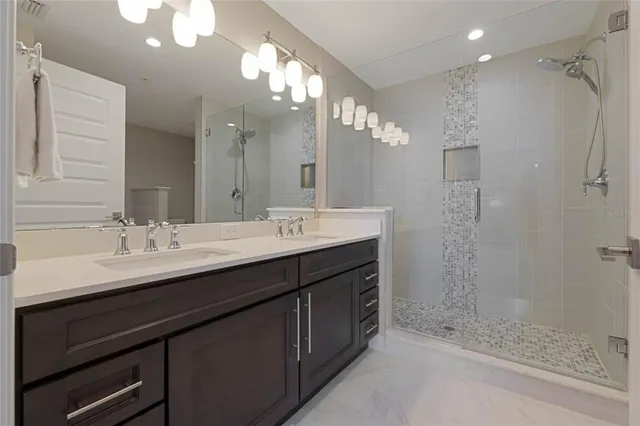 a bathroom with a sink double vanity and a shower