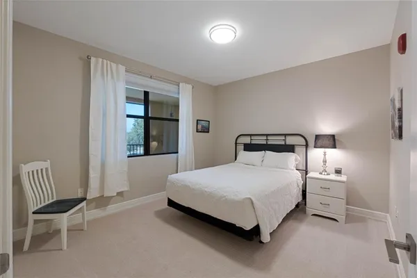 a bedroom with a bed chair and window