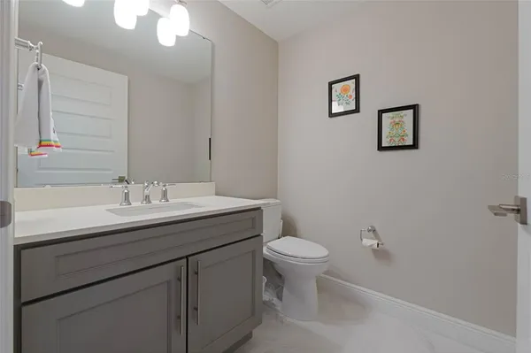 a bathroom with a sink toilet and a mirror
