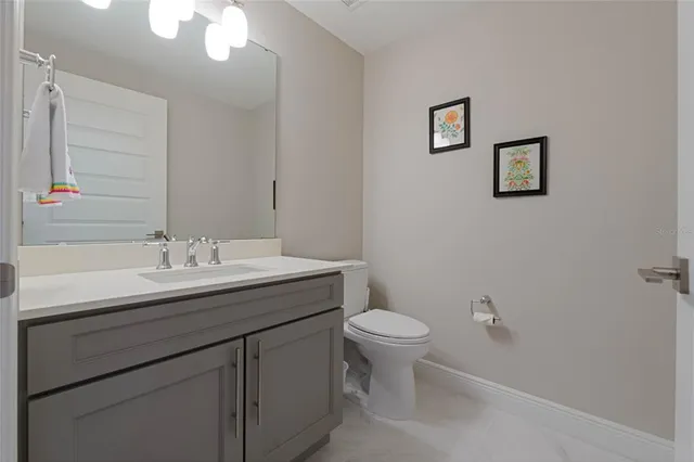 a bathroom with a sink toilet and a mirror