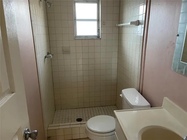 a white toilet and tub sitting next to a bathroom sink