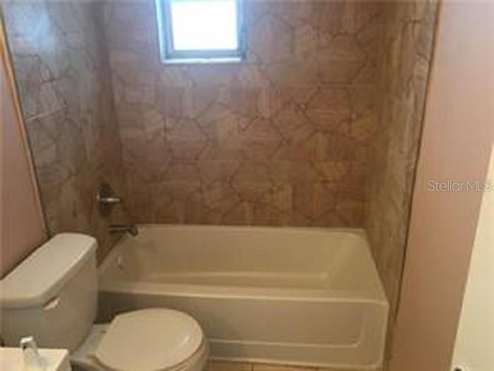 5924 Pine Street New Port Richey, FL 34652 - Photo 14 of 20 a bathroom with a toilet and a bathtub