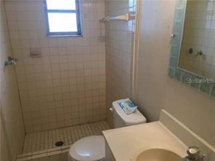 5924 Pine Street New Port Richey, FL 34652 - Photo 17 of 20 a bathroom with a toilet and a shower