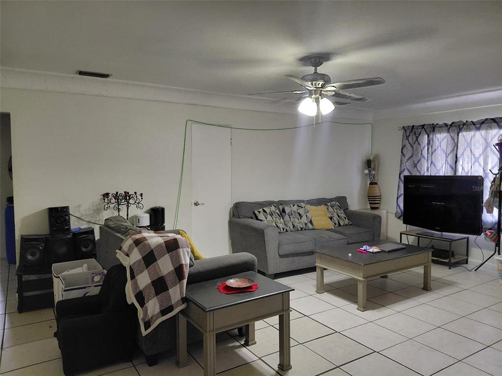 5924 Pine Street New Port Richey, FL 34652 - Photo 3 of 20 a living room with furniture a flat screen tv and a window