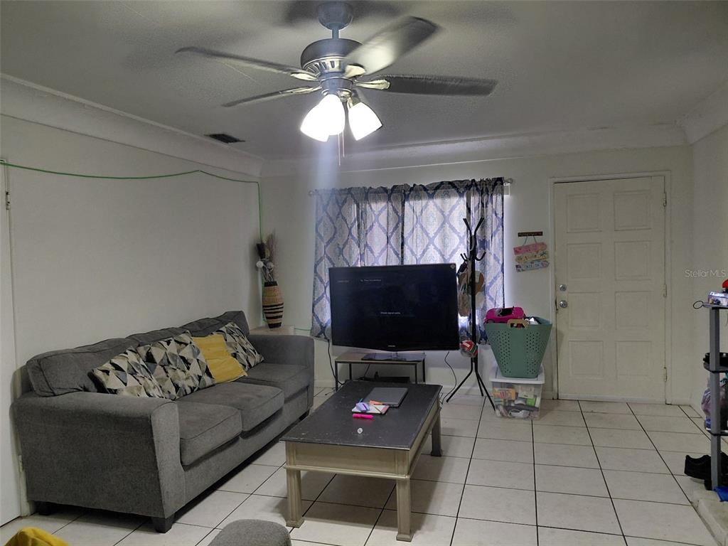 5924 Pine Street New Port Richey, FL 34652 - Photo 5 of 20 a living room with furniture and a flat screen tv