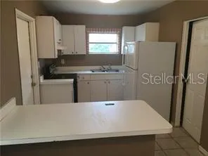 a white toilet sitting next to a bathroom sink and a shower