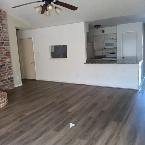 an empty room with wooden floor and closet