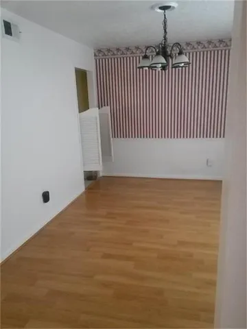 a kitchen with a granite countertop sink and cabinets