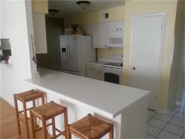 a white toilet sitting next to a shower curtain