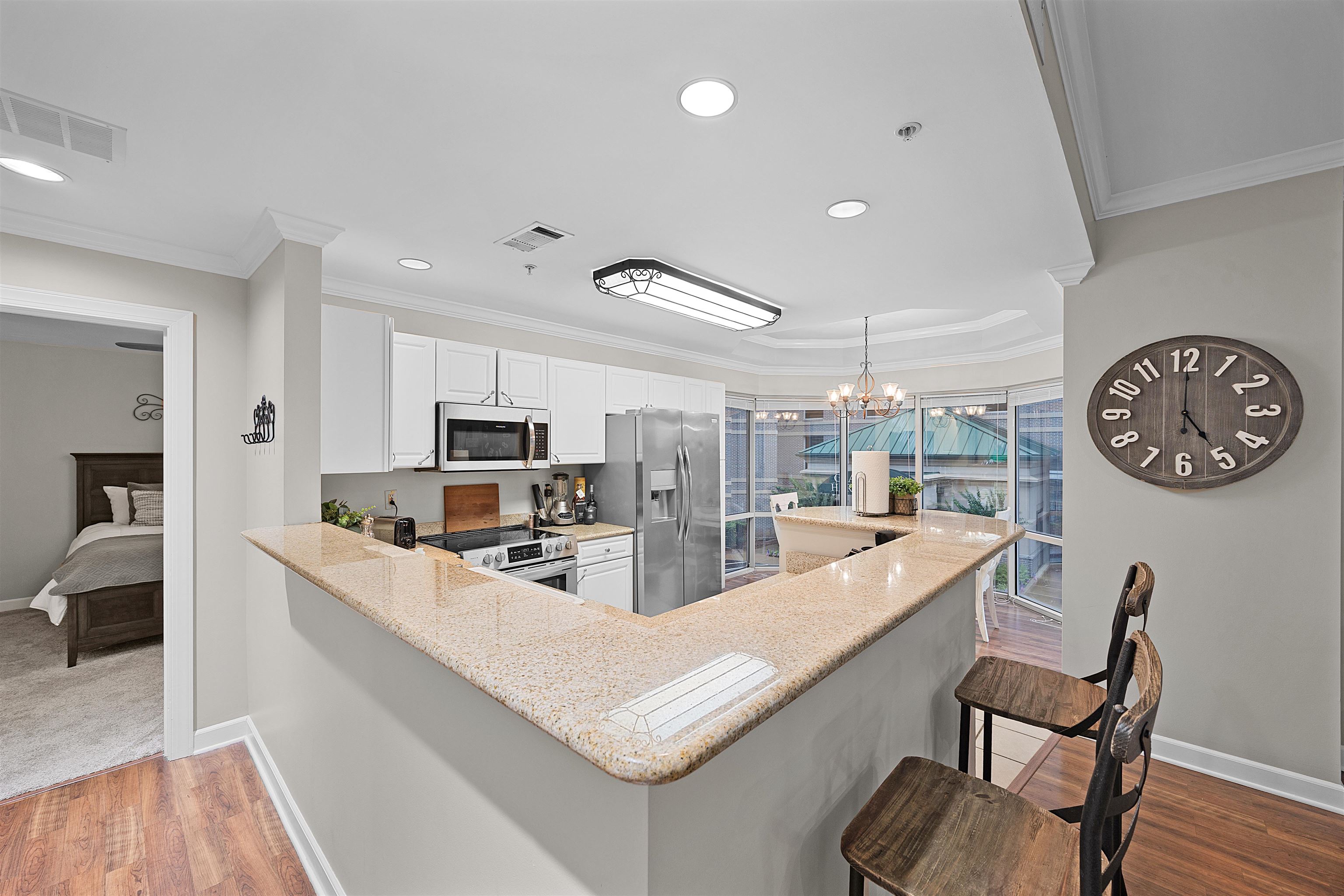 25 Cr 380 Road, Unit P 204 Iuka, MS 38852 - Photo 6 of 19 Kitchen with appliances with stainless steel finishes, ornamental molding, light stone countertops, a breakfast bar, and white cabinetry