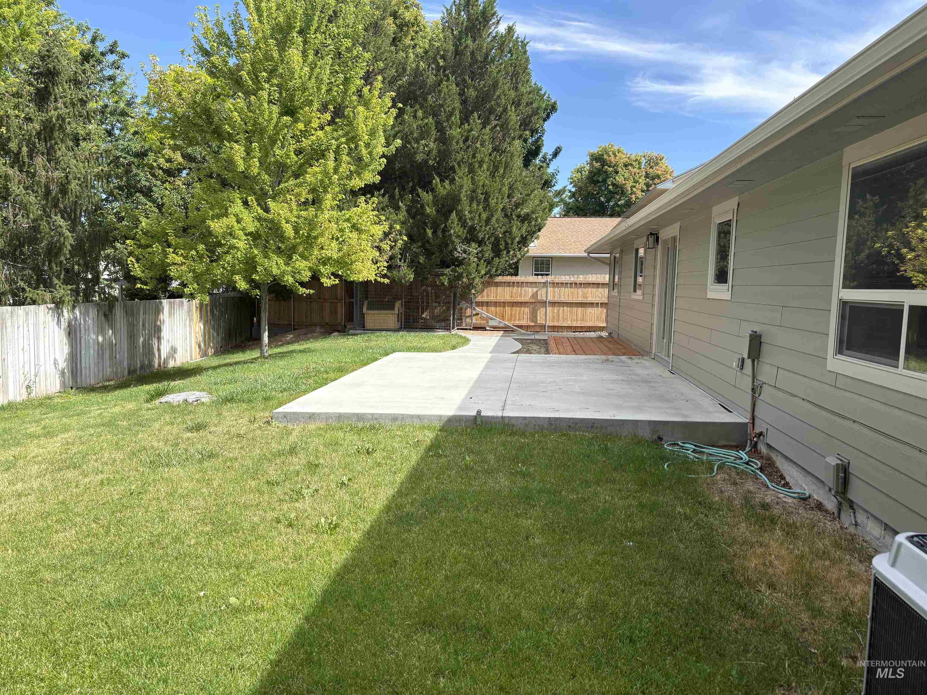 513 Ridge Way Ontario, OR 97914 - Photo 5 of 29 Spacious backyard featuring a concrete patio, wood deck, and perimeter fencing