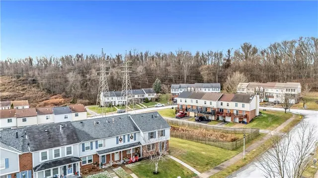 a view of swimming pool with outdoor seating and trees in the background