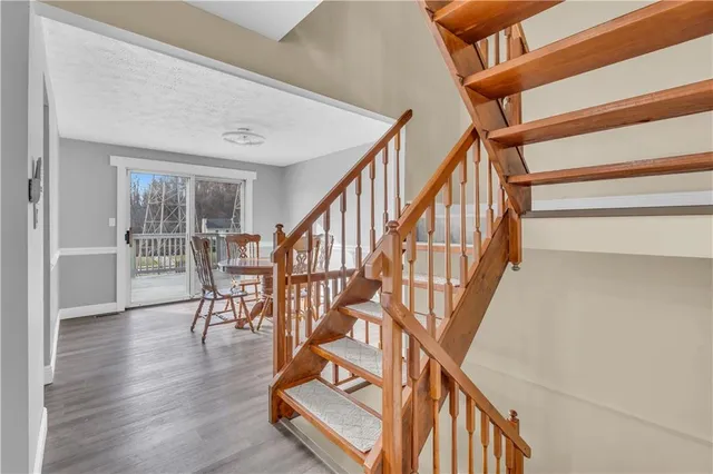 a view of entryway and hall with wooden floor