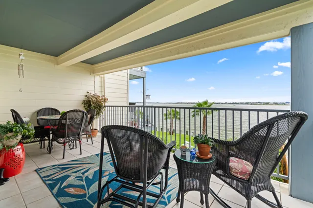 a balcony filled with furniture and rug