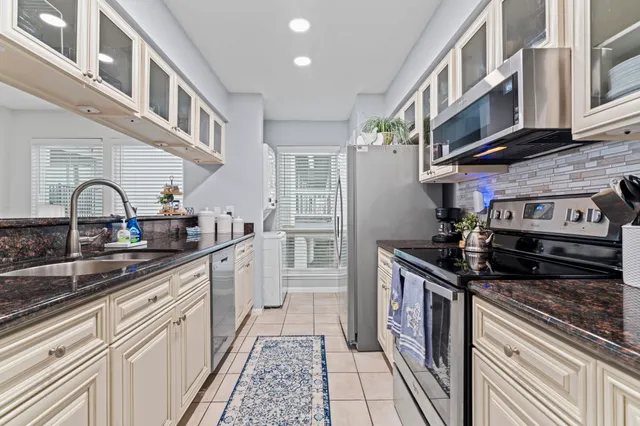 a stove top oven sitting inside of a kitchen