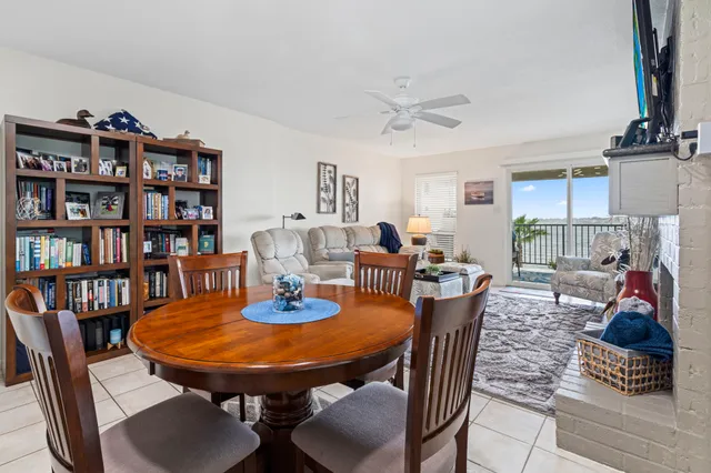 a view of a roof deck with table and chairs