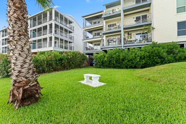 a view of a house with a big yard and large trees