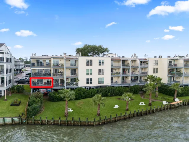 a aerial view of multi story residential apartment building with a yard