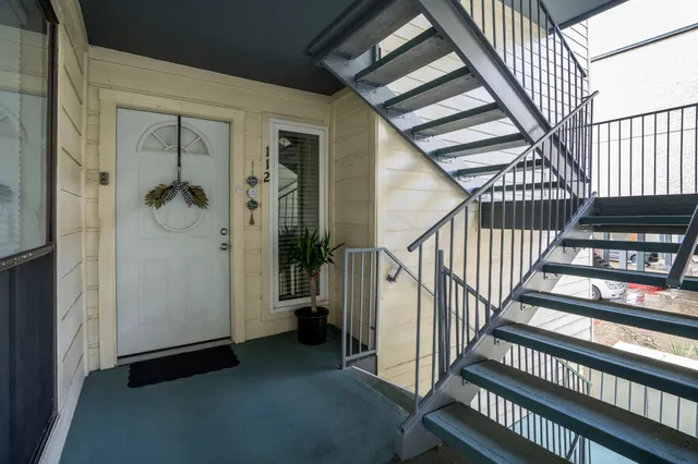 a living room with furniture and a mirror
