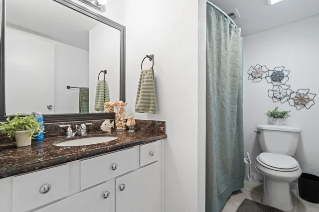 a bedroom with a bed and a potted plant