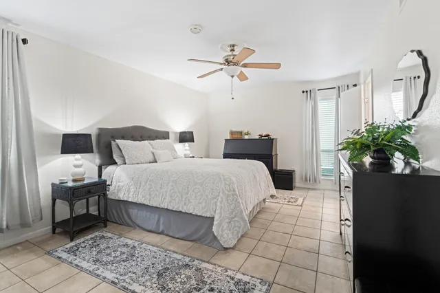 a bedroom with a bed and ceiling fan