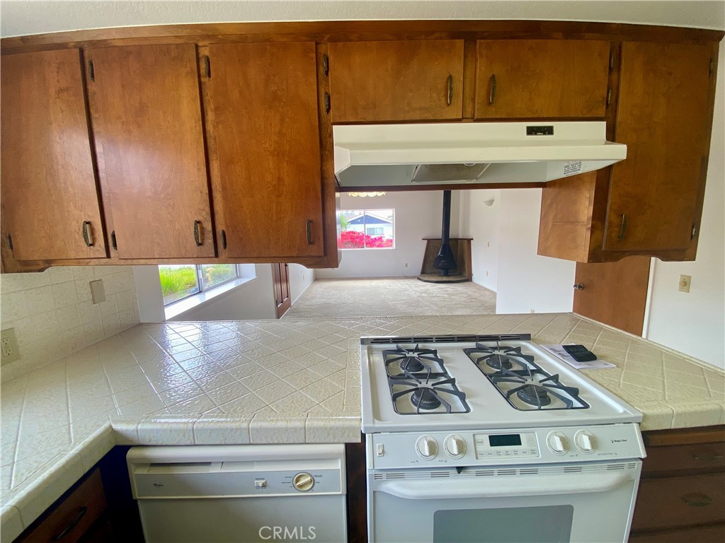 3219 Tide Avenue Morro Bay, CA 93442 - Photo 17 of 23 a kitchen with kitchen island a stove and a sink