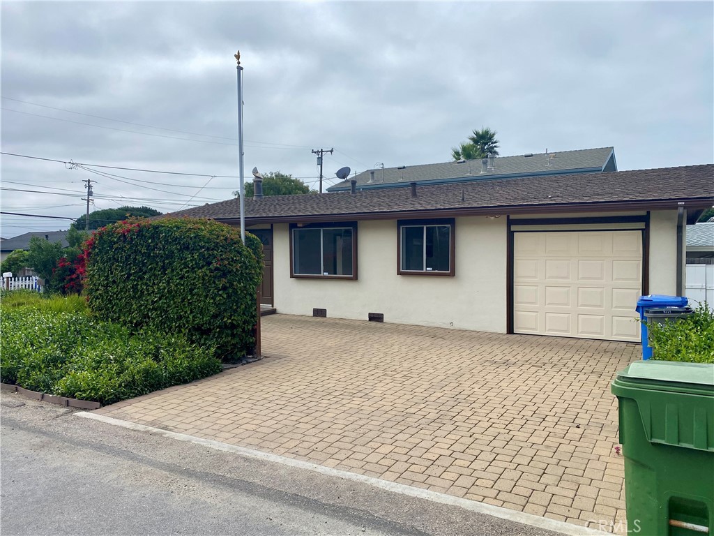 3219 Tide Avenue Morro Bay, CA 93442 - Photo 4 of 23 a front view of a house with a garden