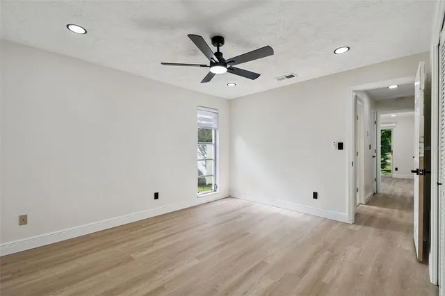 an empty room with fan and a ceiling fan