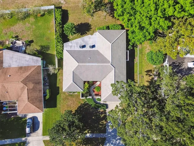 an aerial view of a house with yard and ocean view