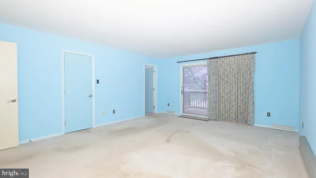 a view of an empty room with closet area