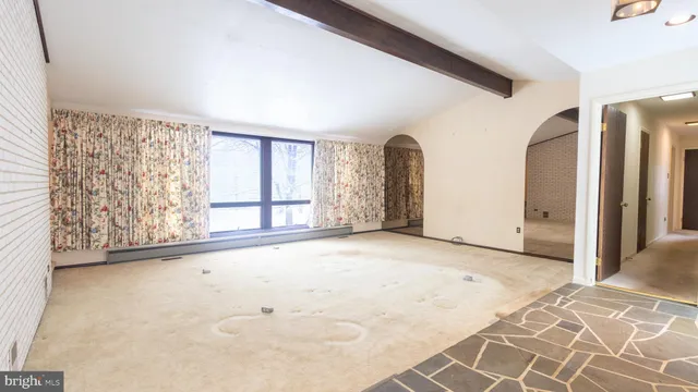a view of a livingroom with wooden floor and a window
