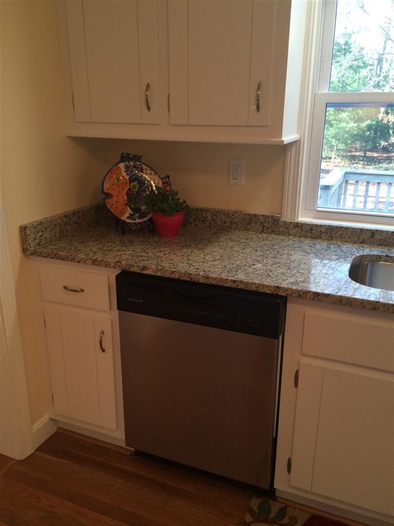 163 Guildford Road Centerville, MA 02632 - Photo 11 of 29 a kitchen with granite countertop white cabinets and a window