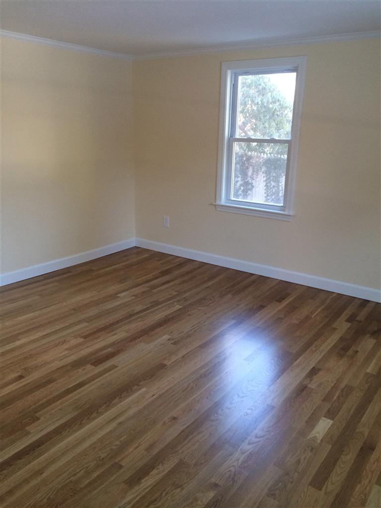 163 Guildford Road Centerville, MA 02632 - Photo 17 of 29 a view of an empty room with wooden floor and a window