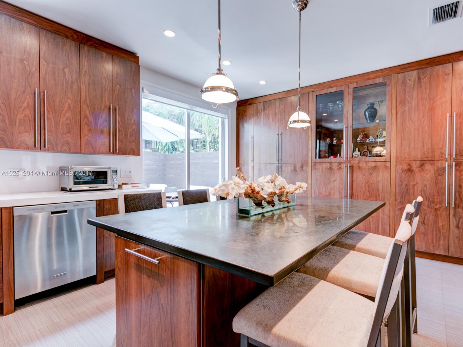 2993 Ruth Street, Unit 2993 Coconut Grove, FL 33133 - Photo 14 of 29 a open kitchen with stainless steel appliances granite countertop a stove a sink a refrigerator dining table and chairs with wooden floor