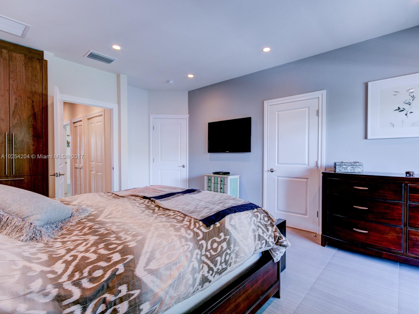 2993 Ruth Street, Unit 2993 Coconut Grove, FL 33133 - Photo 20 of 29 a bedroom with a bed and a television