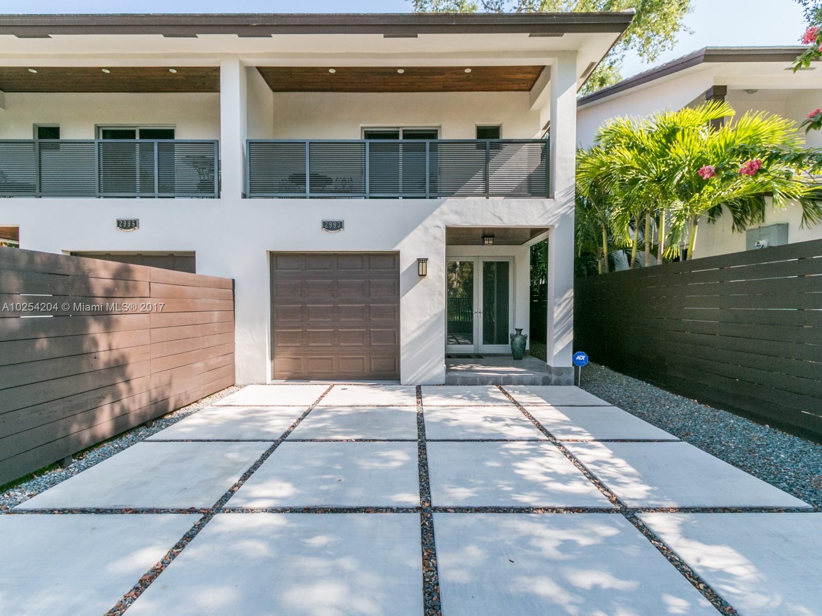 2993 Ruth Street, Unit 2993 Coconut Grove, FL 33133 - Photo 2 of 29 a front view of a house with a yard and garage