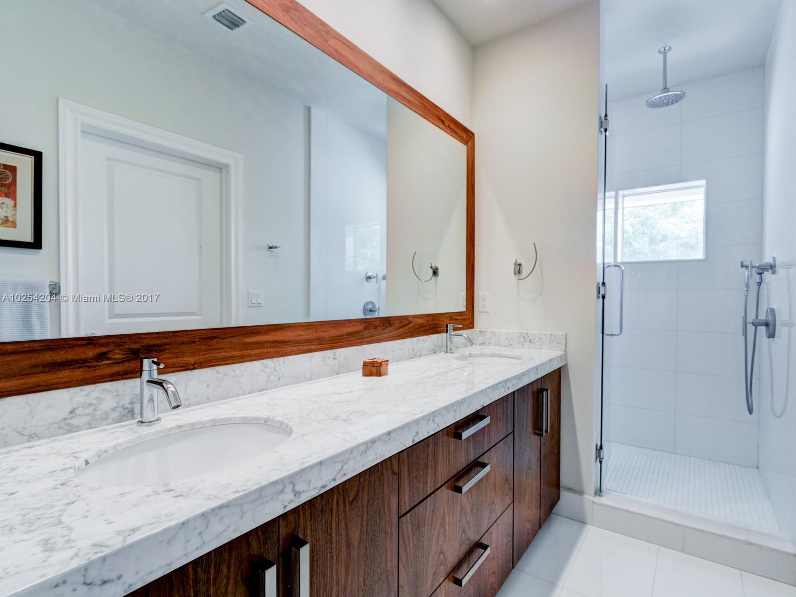 2993 Ruth Street, Unit 2993 Coconut Grove, FL 33133 - Photo 21 of 29 a bathroom with a sink and a mirror